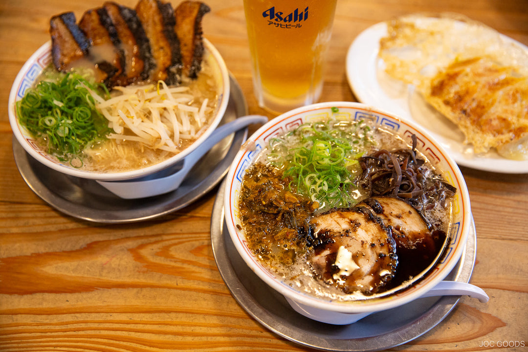 a bowl of ramen in a white bowl on table