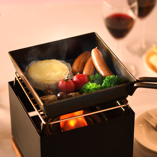 Luxe Tabletop Grill with a mini frying pan on top, offering versatile cooking options for a convenient and efficient meal preparation.


