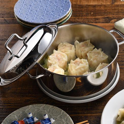 Compact stainless steel steamer placed on the table, serving freshly steamed ingredients directly for a convenient dining experience.