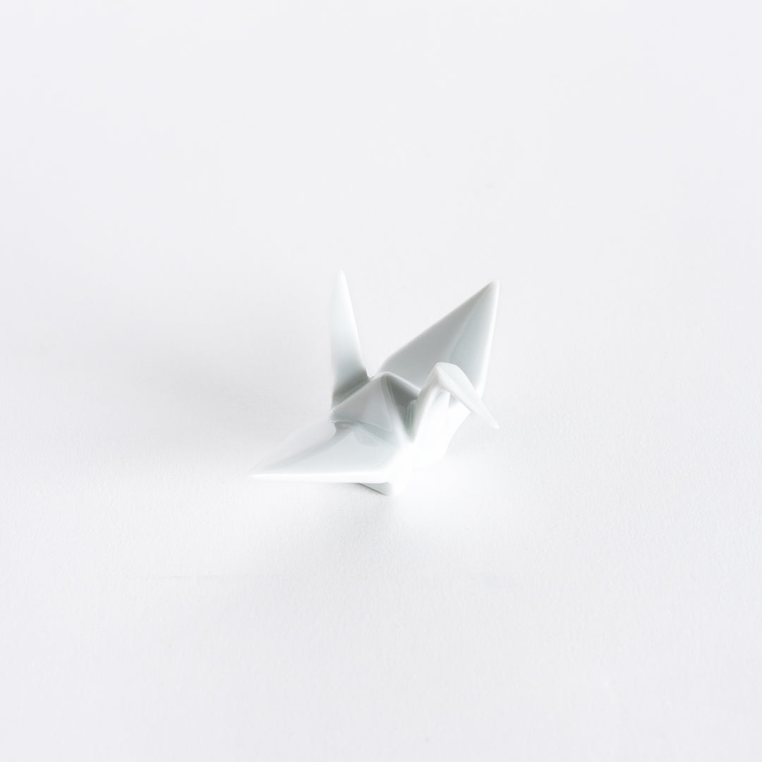 A white ceramic crane-shaped chopstick rest on a white background.