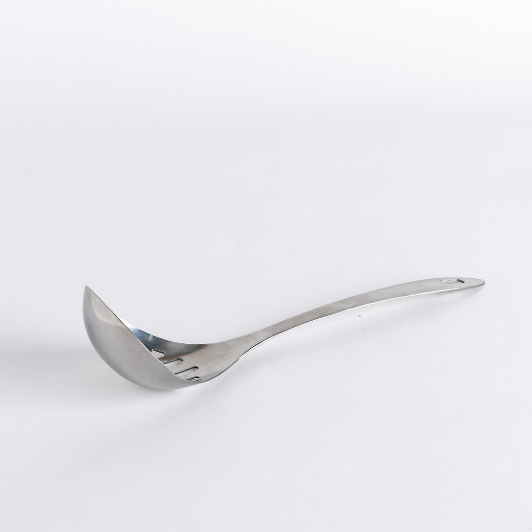 A stainless steel ladle with small drainage holes and a wide, deep scoop, designed for straining while serving.