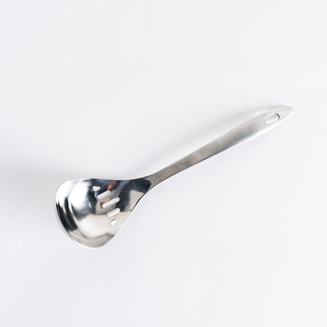 A stainless steel ladle with small drainage holes and a wide, deep scoop, designed for straining while serving.