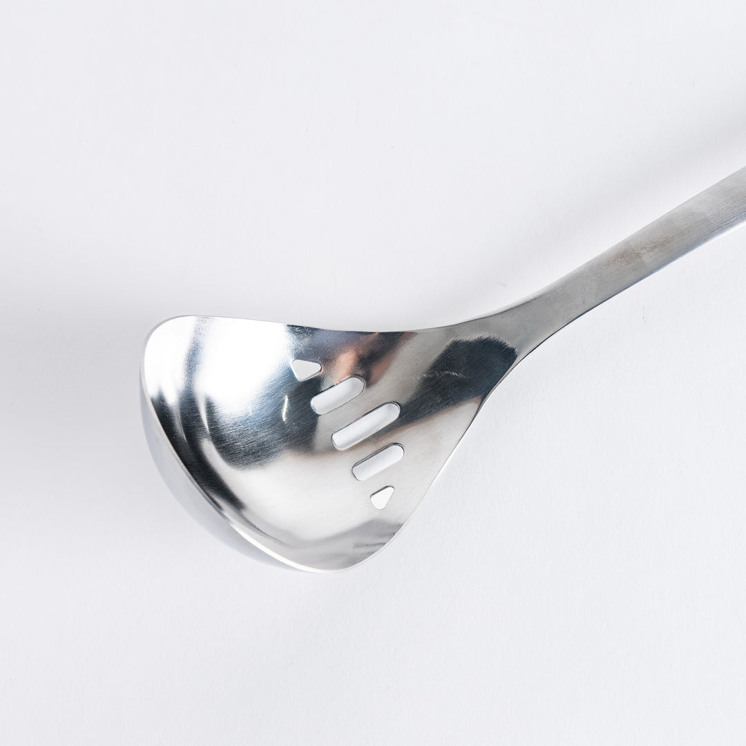 A stainless steel ladle with small drainage holes and a wide, deep scoop, designed for straining while serving.