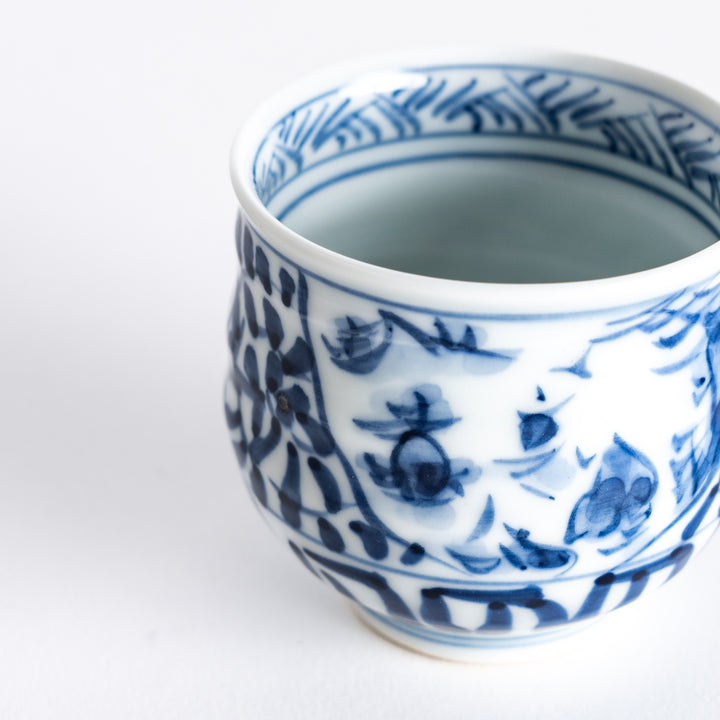 Close-up view of the sake cup, displaying the fine details of the blue arabesque design.