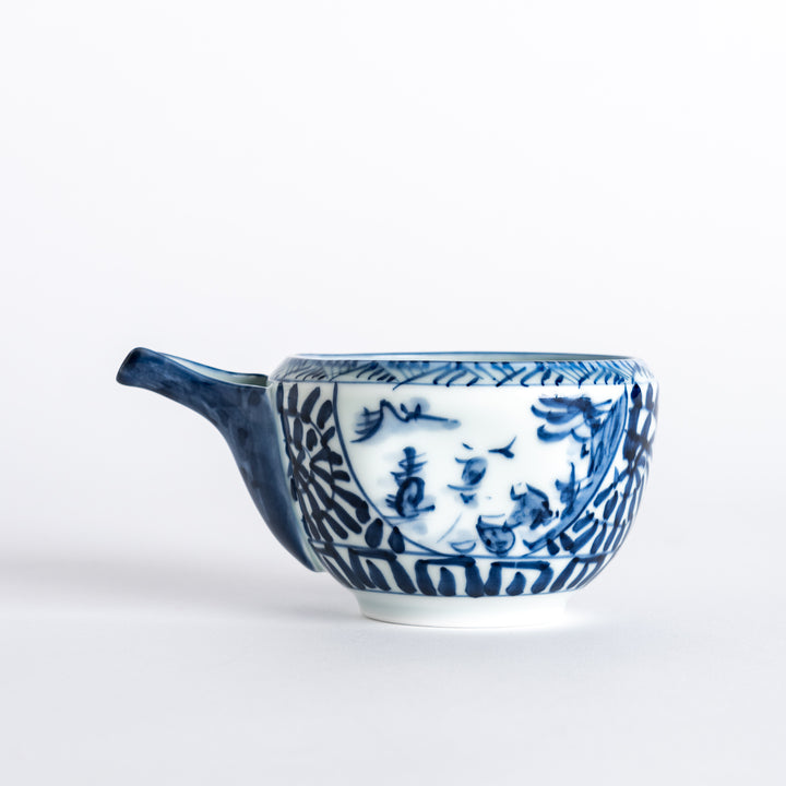 Side view of the sake pourer featuring a detailed blue arabesque landscape design, with a spout on the side.