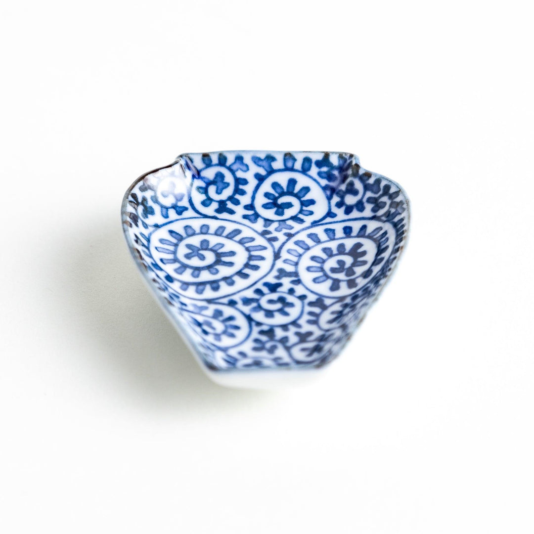 Jar-shaped plate with a blue floral spiral design.