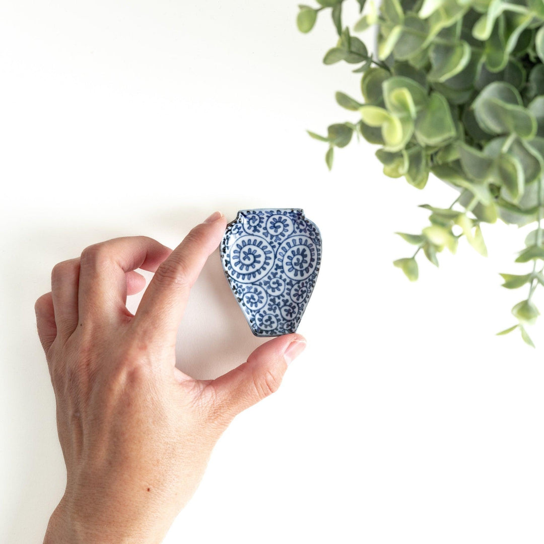 Jar-shaped plate with a blue floral spiral design.