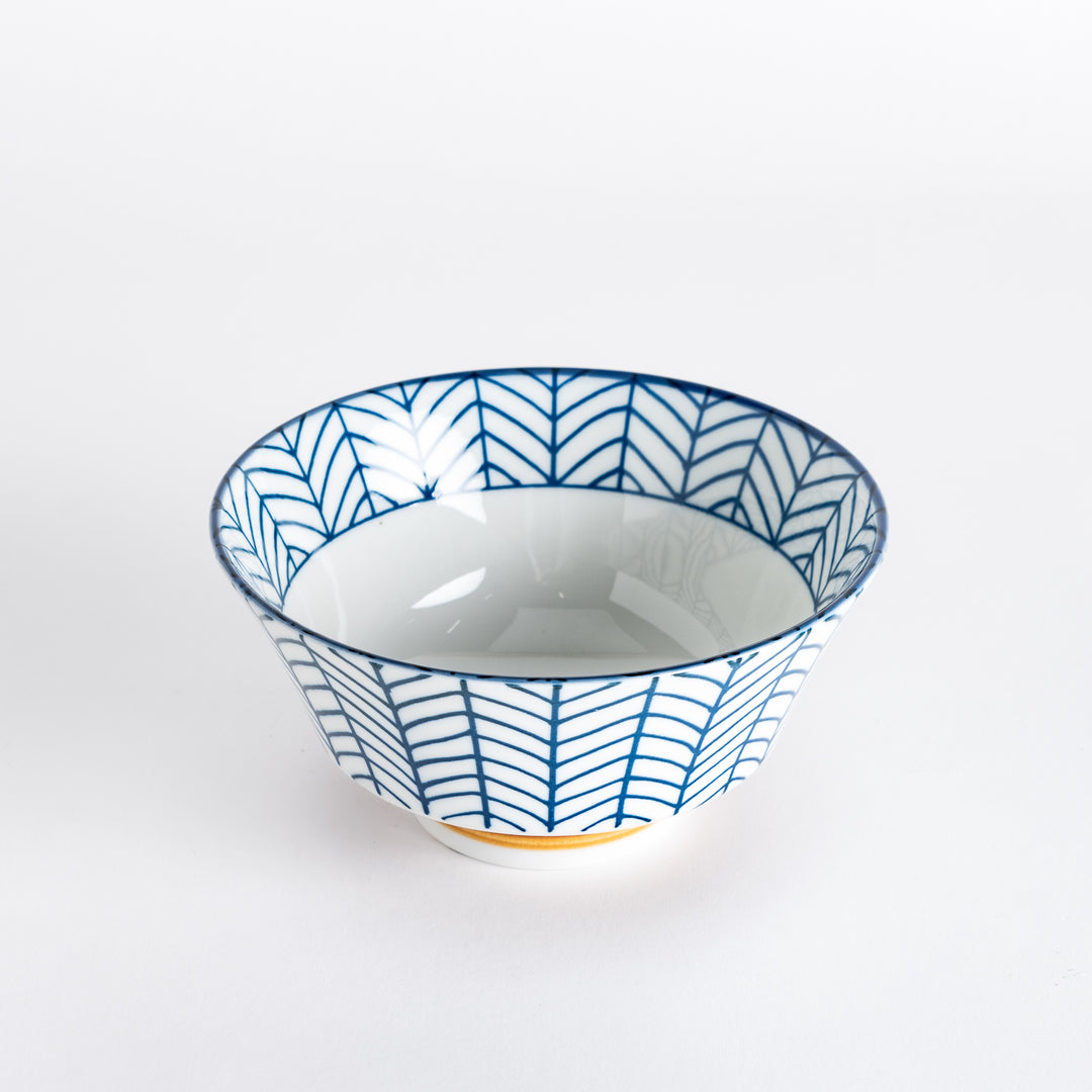 Ceramic ramen bowl with blue striped pattern on white background.