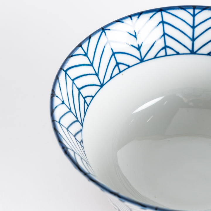 Ceramic ramen bowl with blue striped pattern on white background.