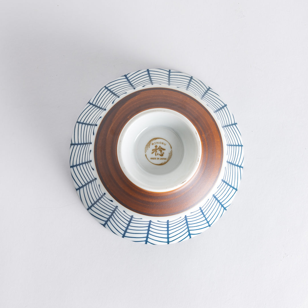 Ceramic ramen bowl with blue striped pattern on white background.