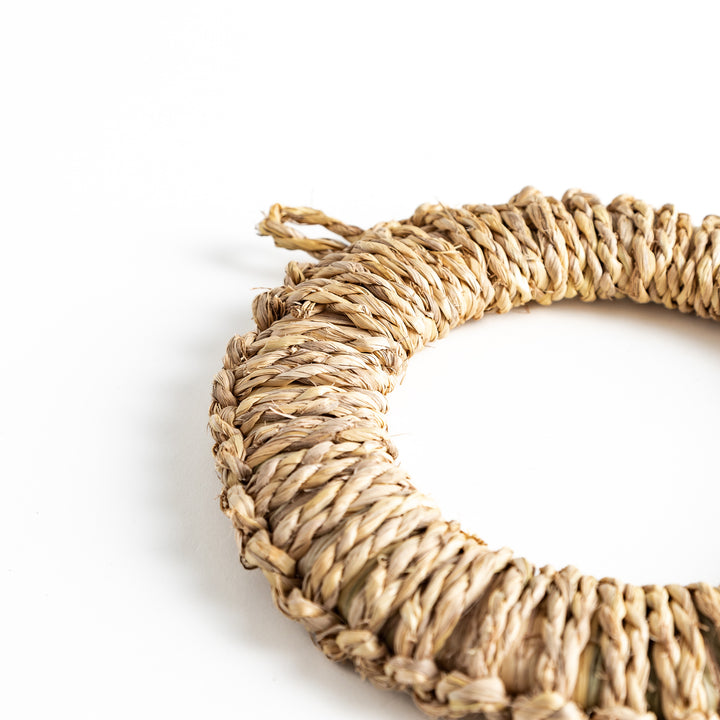 Handwoven rush trivet in large size, captured from the side to highlight the sturdy, round structure and smooth edges.