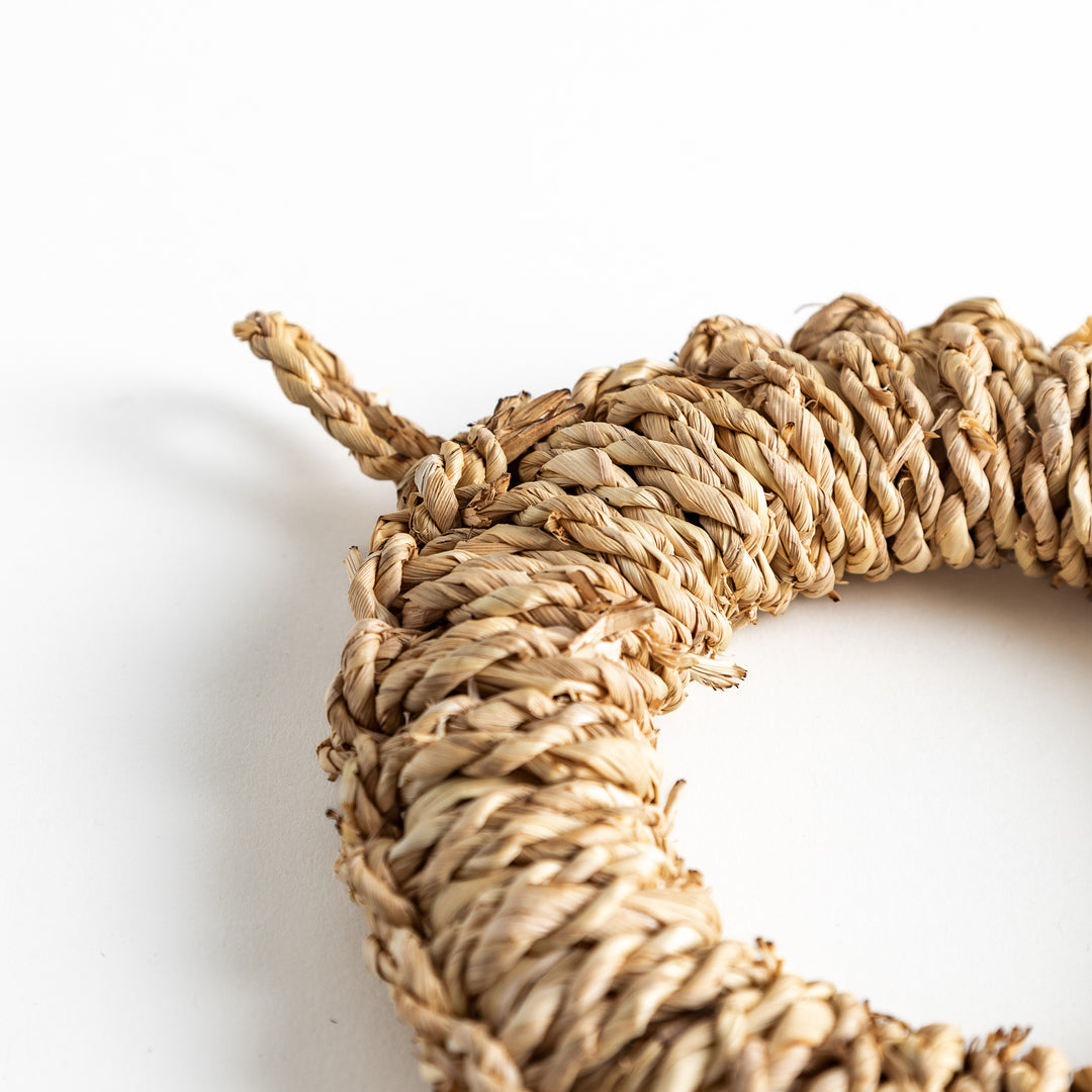 Detailed view of an artisan rush trivet, emphasizing the texture and craftsmanship of the natural materials.