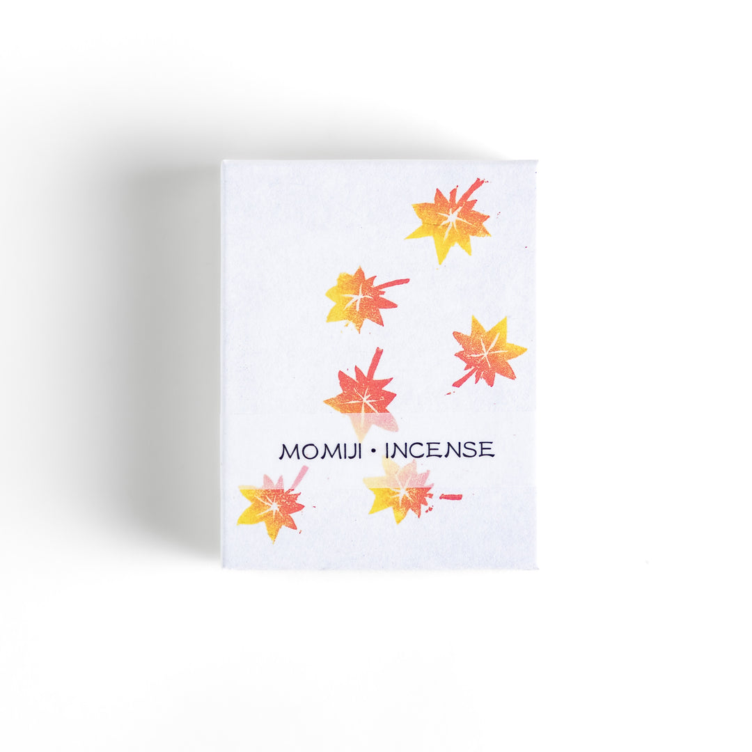 Incense featuring warm-toned sticks in a box decorated with vibrant autumn maple leaves, offering a rich, earthy fragrance inspired by the essence of fall.