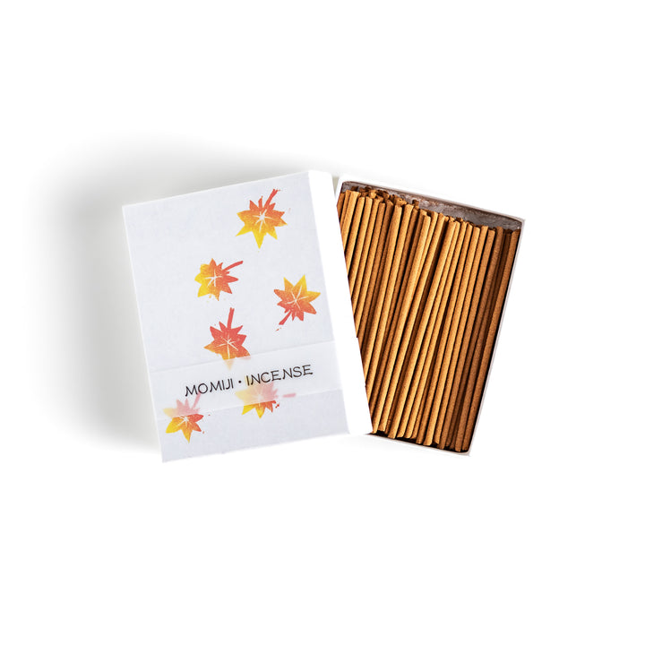 Incense featuring warm-toned sticks in a box decorated with vibrant autumn maple leaves, offering a rich, earthy fragrance inspired by the essence of fall.