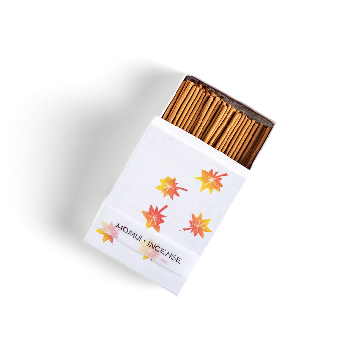 Incense featuring warm-toned sticks in a box decorated with vibrant autumn maple leaves, offering a rich, earthy fragrance inspired by the essence of fall.