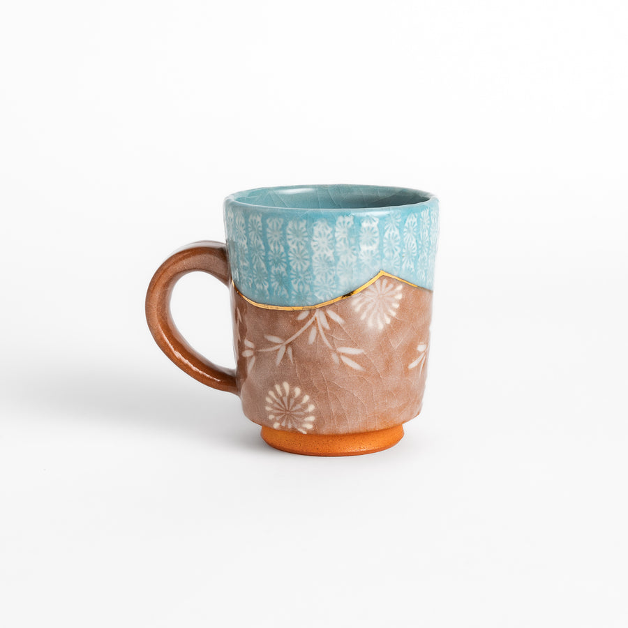 Azure floral elegance mug with delicate flower patterns and gold detailing on the rim, perfect for enjoying hot beverages in style.