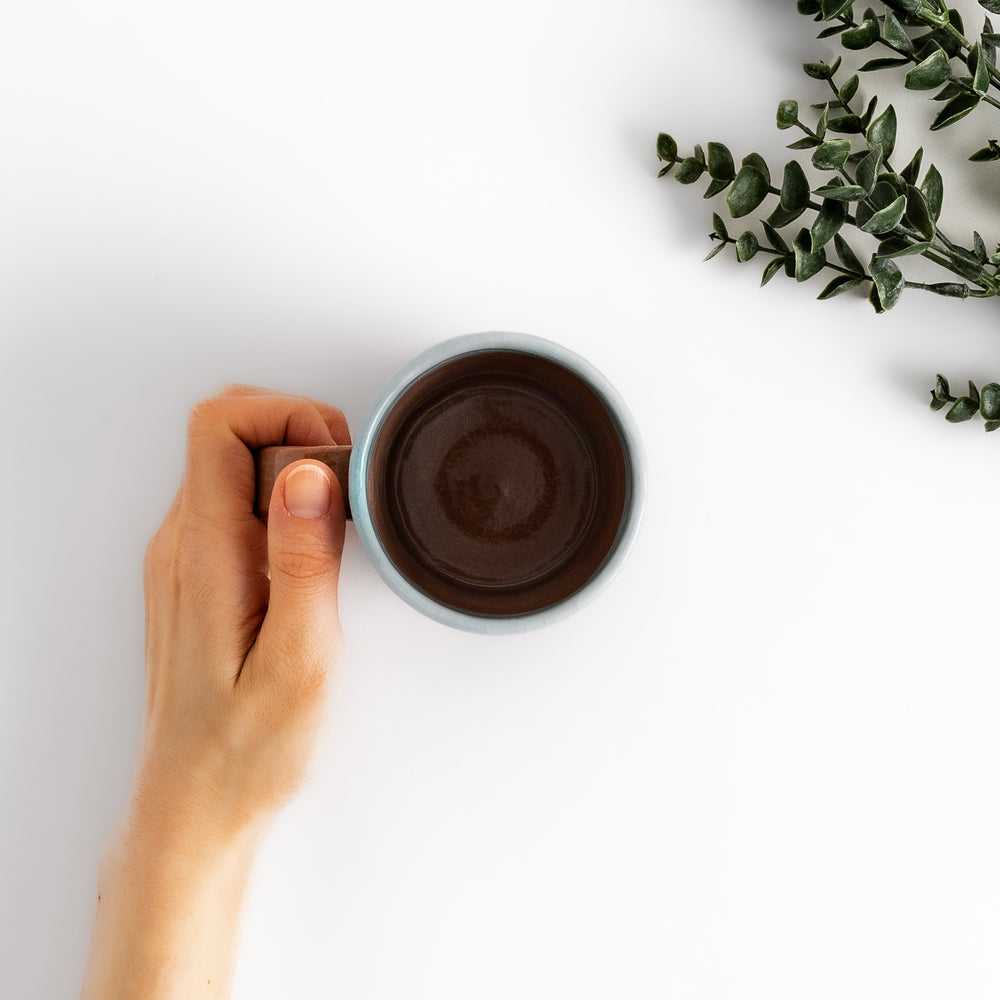 Azure floral elegance mug with delicate flower patterns and gold detailing on the rim, perfect for enjoying hot beverages in style.