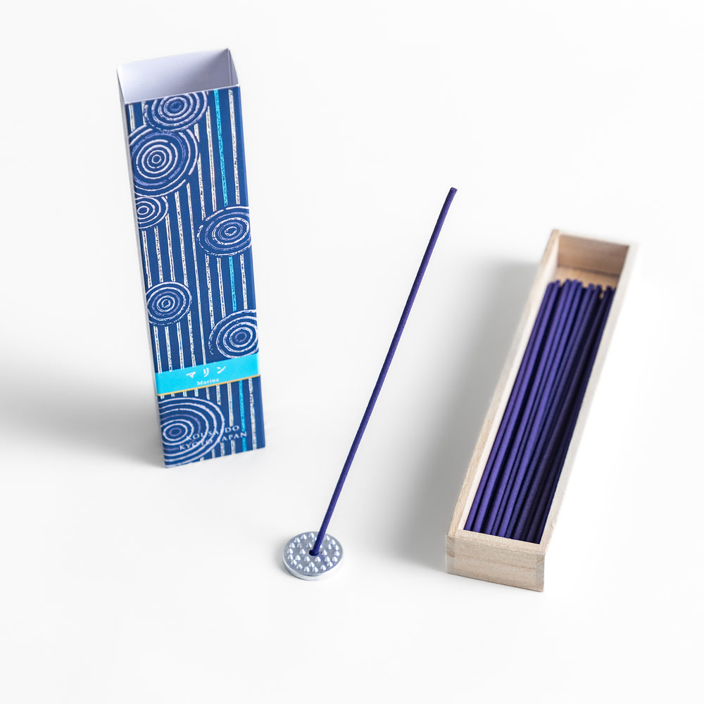 Azure Marine Incense in a light wooden box with deep blue sticks, elegantly packaged in a navy design featuring white circular patterns, evoking a refreshing and invigorating ocean breeze aroma.