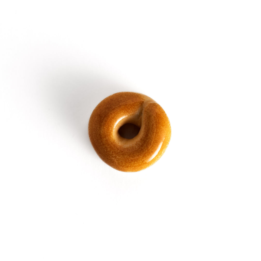 Top view of the bagel-shaped chopsticks rest, showcasing its smooth finish and circular design with a central hole.