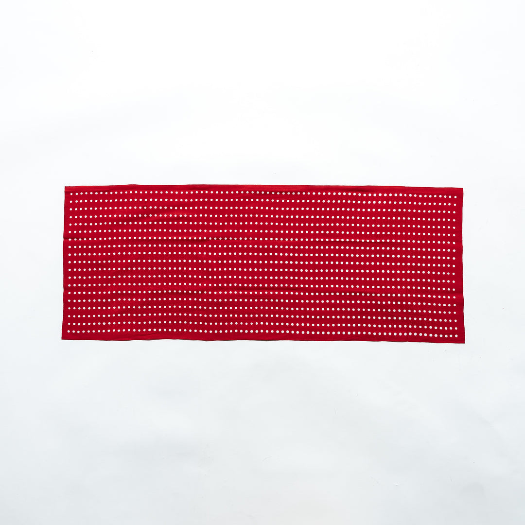 Red tenugui fully laid out, featuring white bean dot patterns in rows.