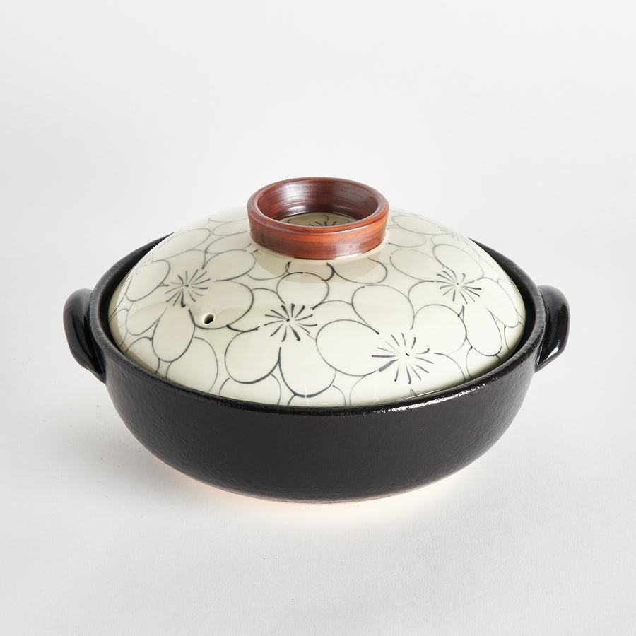 Elegant donabe with floral patterned lid and earthy brown rim, perfect for adding a traditional touch to any kitchen.