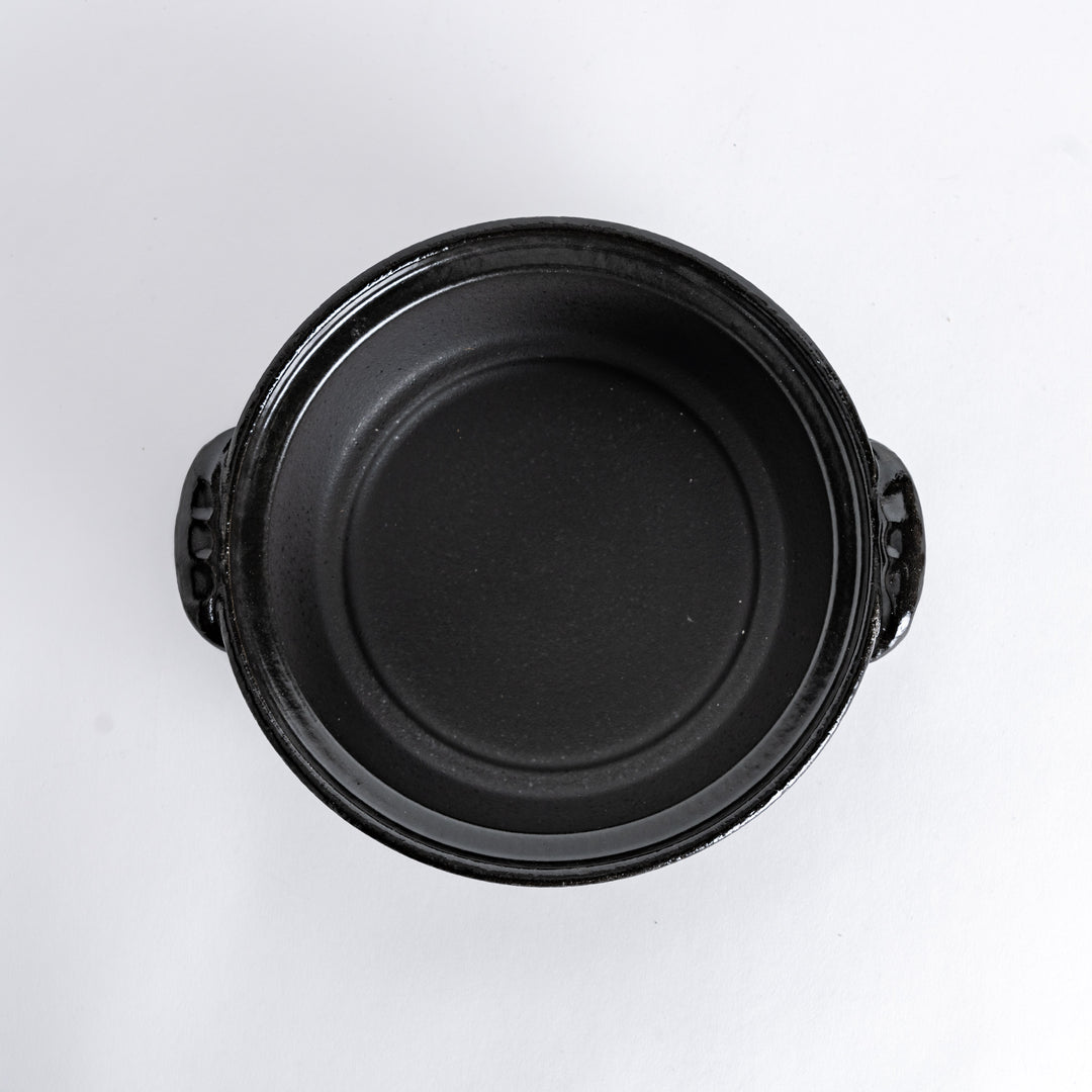 A 8-inch donabe with a vibrant black floral pattern lid and black pot.