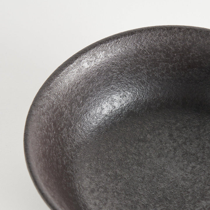 A bowl with a textured, matte black finish, offering a rustic aesthetic.