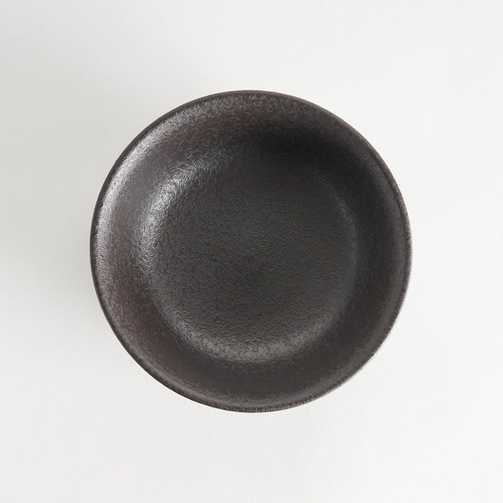 A bowl with a textured, matte black finish, offering a rustic aesthetic.