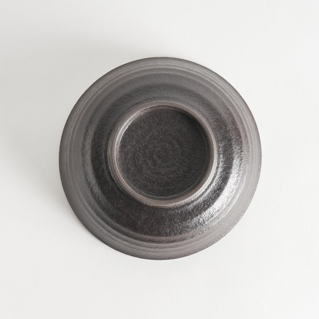 A bowl with a textured, matte black finish, offering a rustic aesthetic.