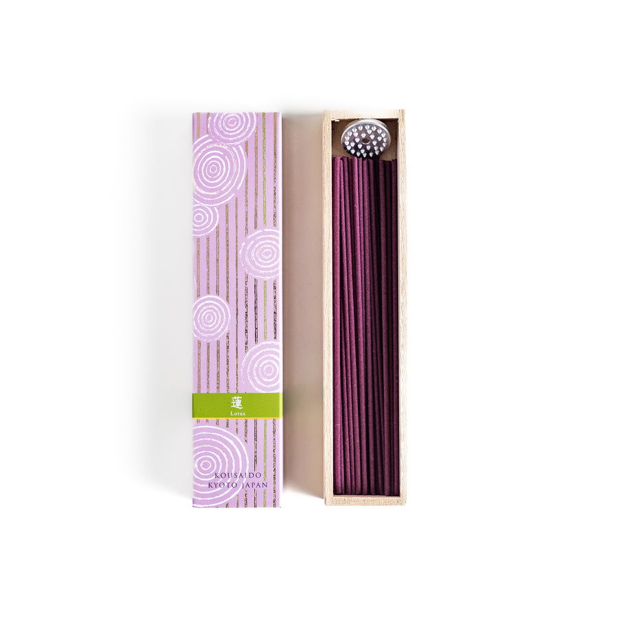 Incense in a light wooden box with rich purple sticks, presented in elegant packaging featuring white circular patterns on a soft lavender background for a serene ambiance.