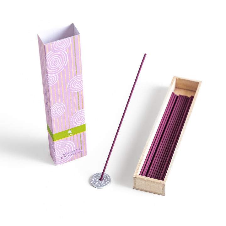 Incense in a light wooden box with rich purple sticks, presented in elegant packaging featuring white circular patterns on a soft lavender background for a serene ambiance.