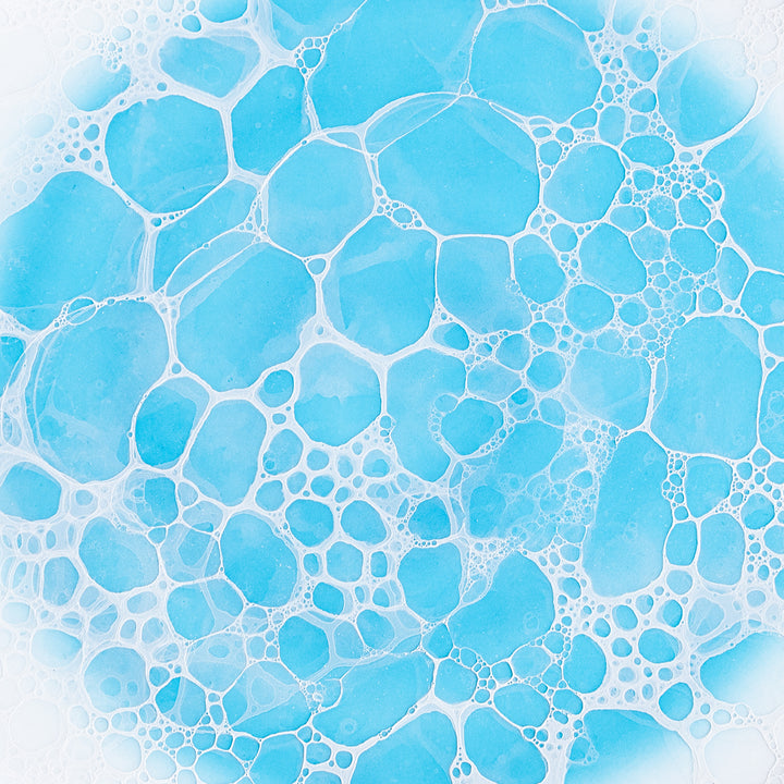 Close-up of the central bubble pattern on the plate, emphasizing the detailed blue bubbles against the white background.