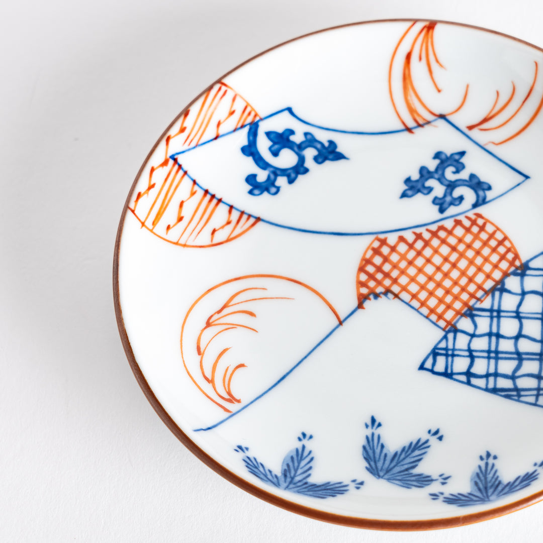 Close-up of the sauce dish showing the detailed blue fan pattern and colorful depiction of Mount Fuji.