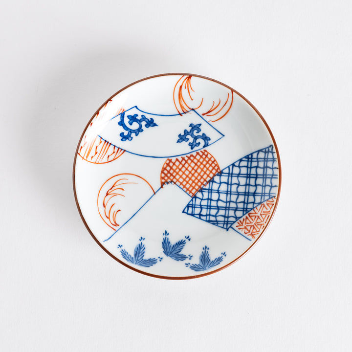 Top view of a sauce dish featuring a blue fan pattern and scenic depiction of Mount Fuji, showcasing its intricate design.