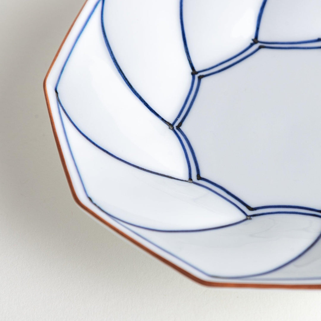 Octagonal dessert plate with a petal design and bowl shape, outlined in blue and red with a brown rim.