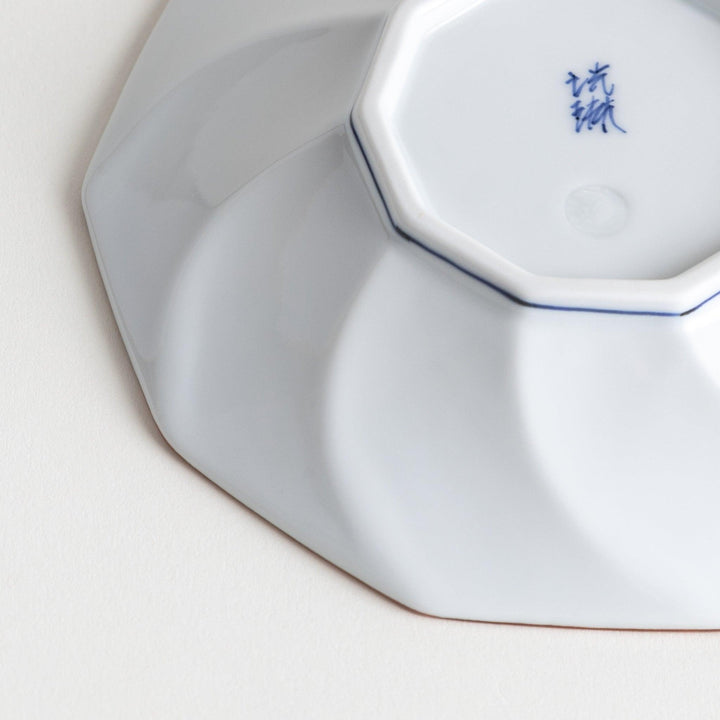 Octagonal dessert plate with a petal design and bowl shape, outlined in blue and red with a brown rim.