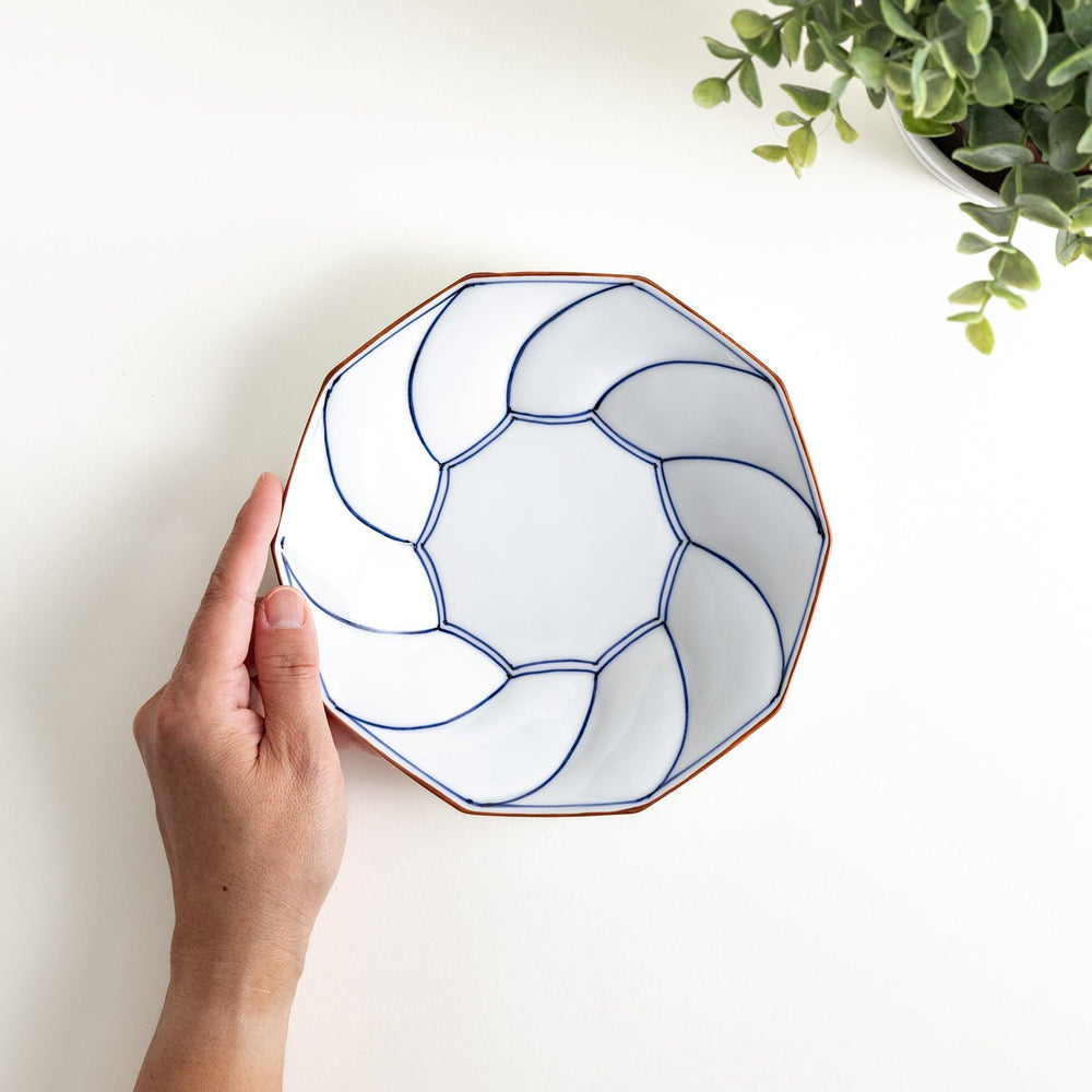 Medium-sized octagonal salad plate with a petal design and bowl shape, outlined in blue and red with a brown rim.