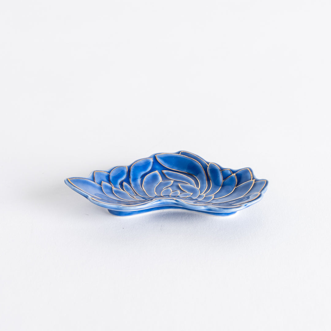 A beautifully detailed blue mini sauce dish with a gold chrysanthemum design. The dish has a wavy, petal-like shape.