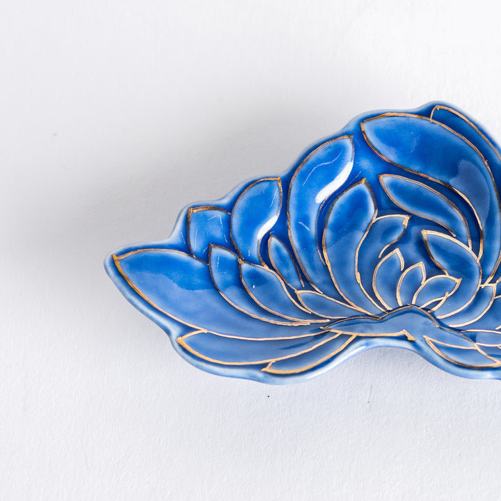 Close-up of the blue mini sauce dish, showing its gold chrysanthemum design and intricate detailing along the edges.