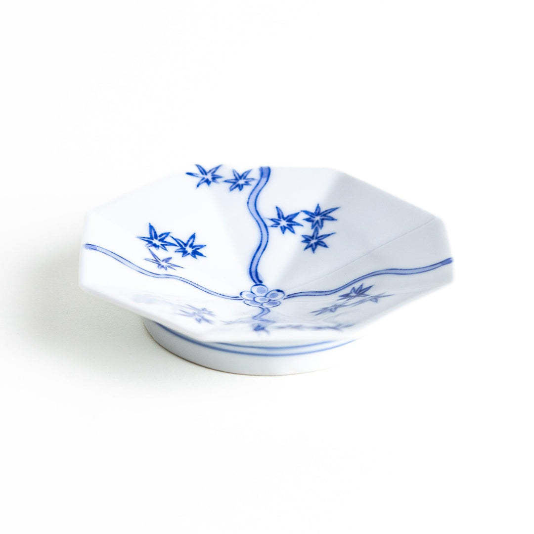 Octagonal white plate with blue floral patterns and curved lines.