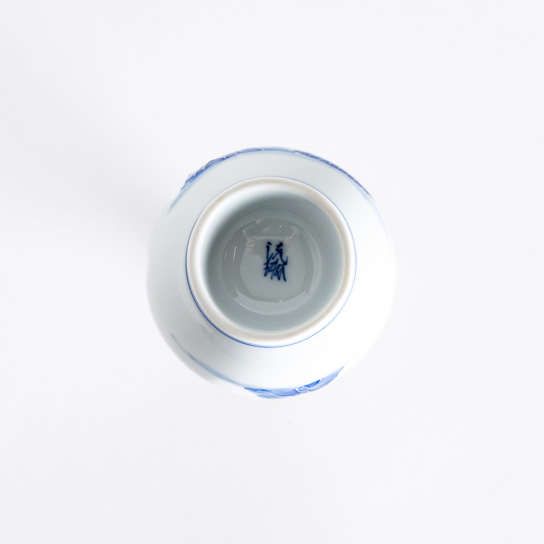 Bottom view of the blue and white sake flask, showing a smooth porcelain base with a minimal design.