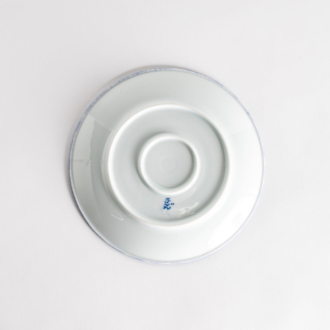 Bottom view of the blue sesame salad plate with a clear view of the smooth base and the maker's mark in blue.