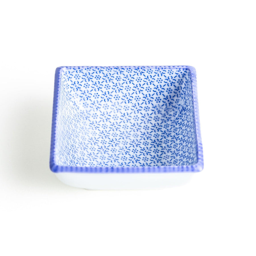 A square bowl with a blue geometric pattern and a light blue rim.