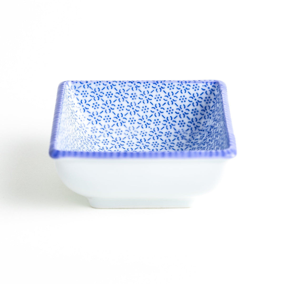 A square bowl with a blue geometric pattern and a light blue rim.