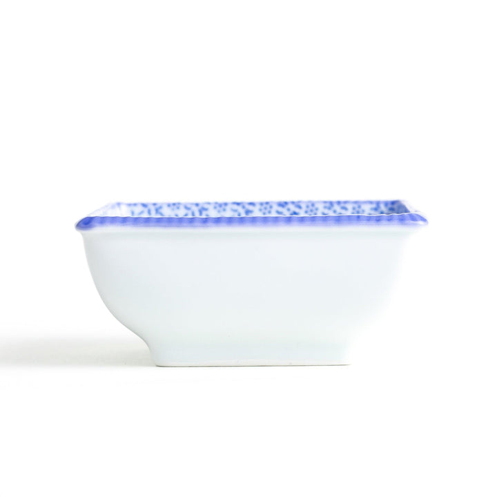 A square bowl with a blue geometric pattern and a light blue rim.