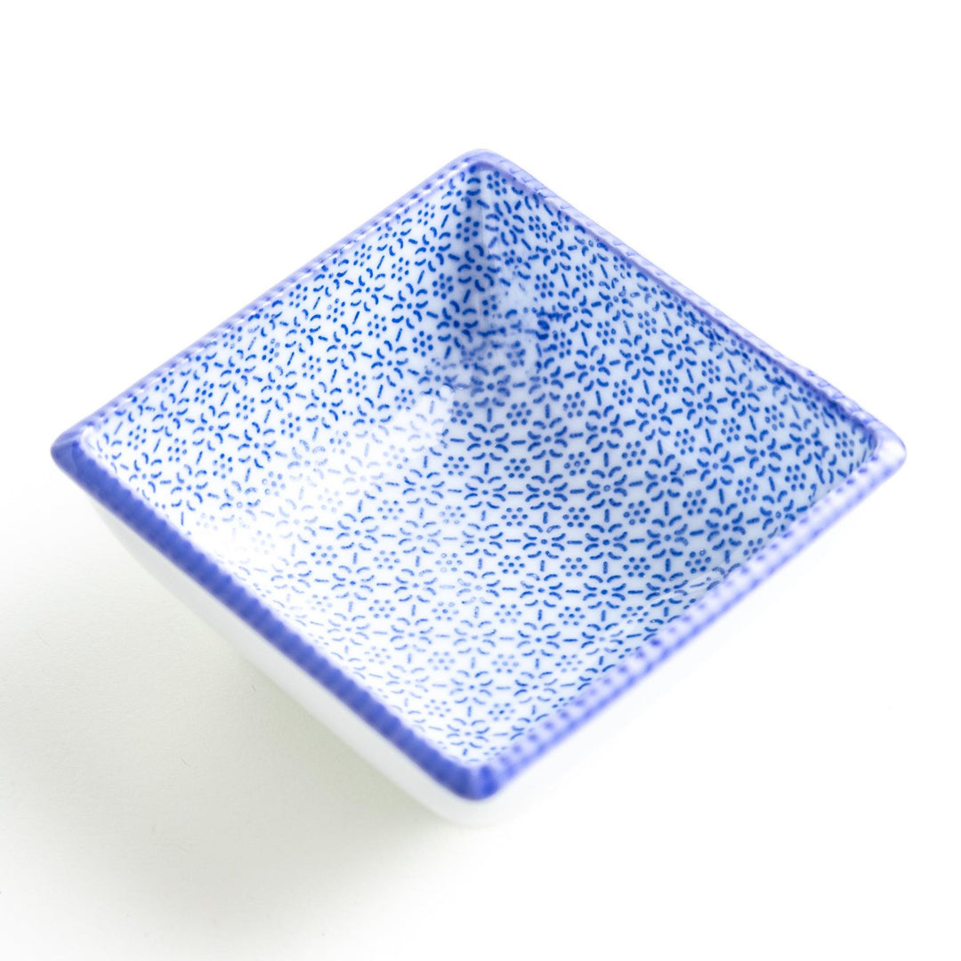 A square bowl with a blue geometric pattern and a light blue rim.