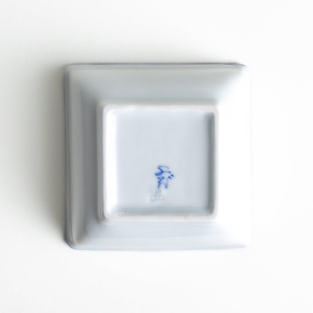 A square bowl with a blue geometric pattern and a light blue rim.