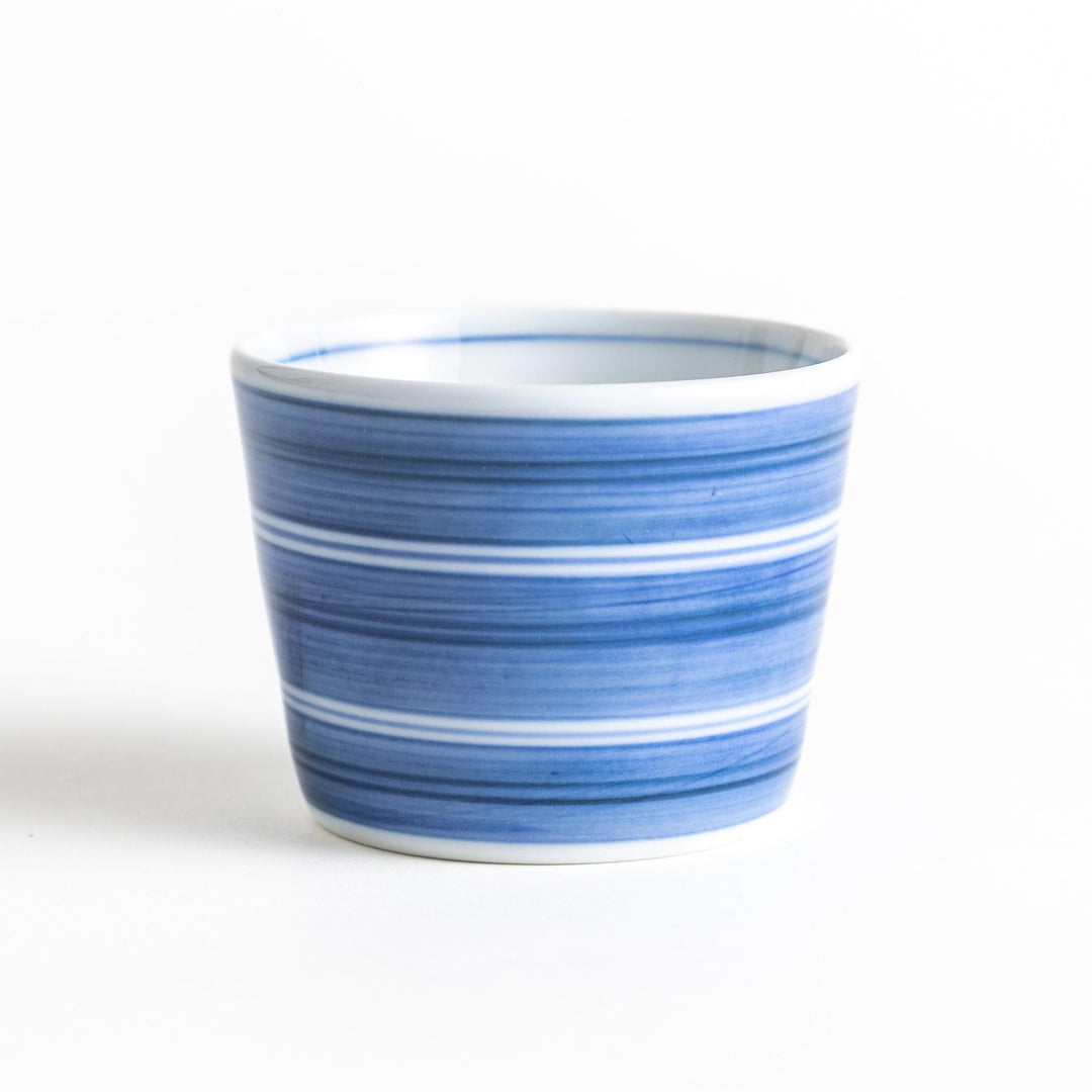 A small condiment bowl with horizontal blue or red stripes of varying shades, creating a minimalist yet elegant design.