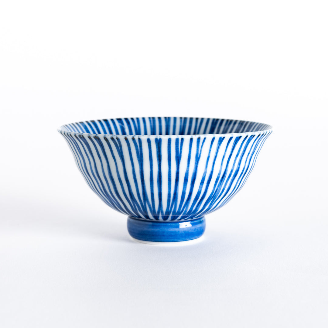 Front view of a blue-striped rice bowl with flared edges and an elevated round base.