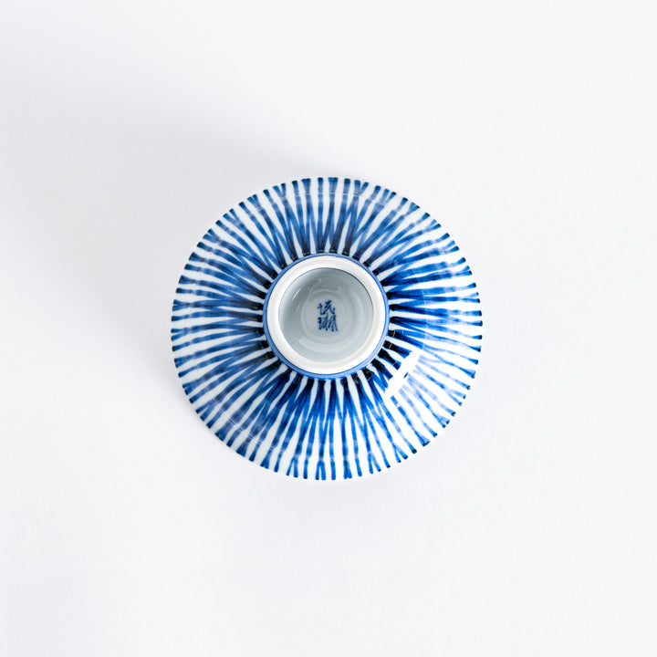 Bottom view of the rice bowl showcasing its small round base and the continuation of the blue-striped design.